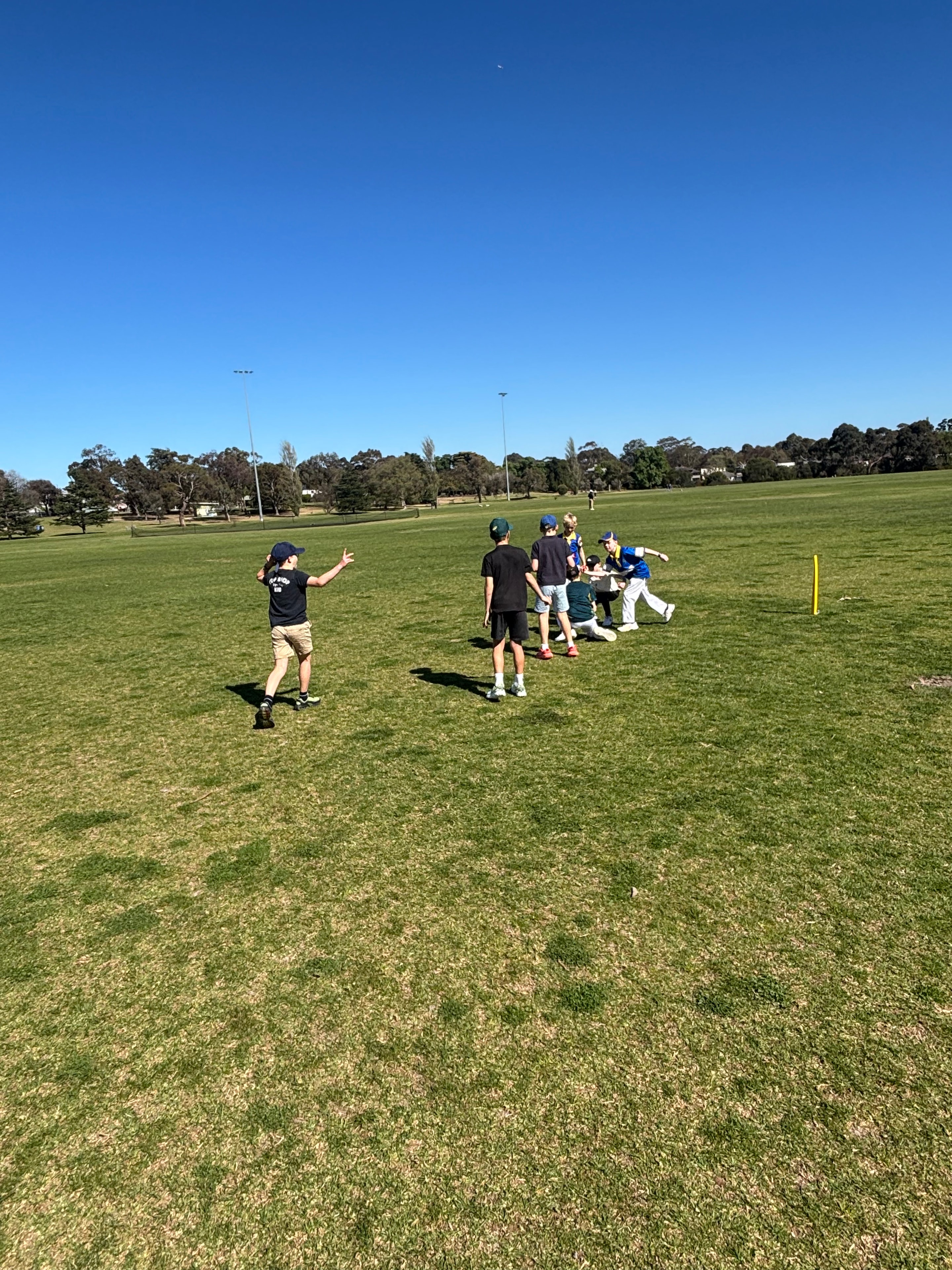Ollie coaching a young cricketer